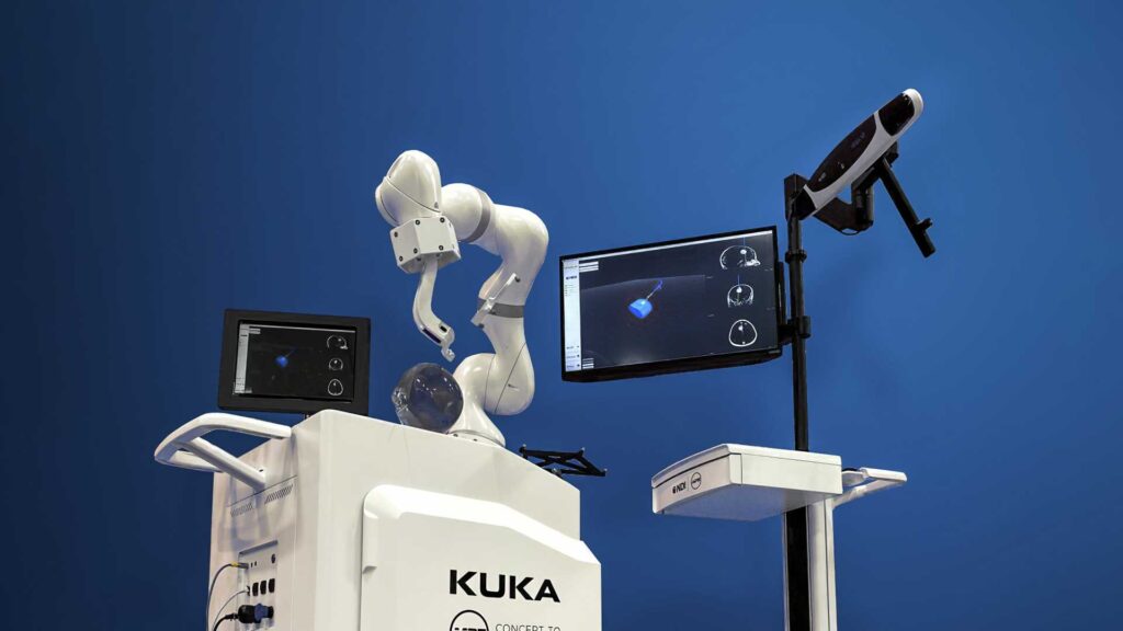 KUKA robotic system with optical tracker and navigation display.