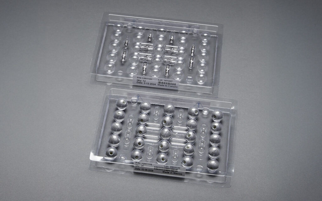 Polaris tool developer kit with passive spheres and mounting posts arranged in plastic trays.