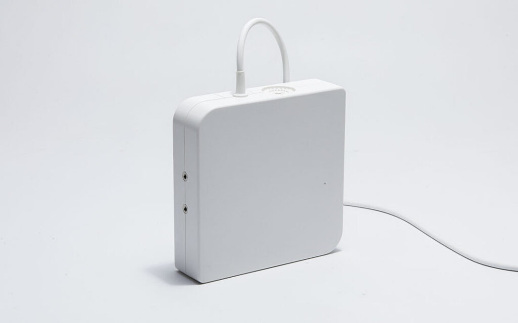 White Aurora System Control Unit with attached field generator cable and connector ports on the side panel.